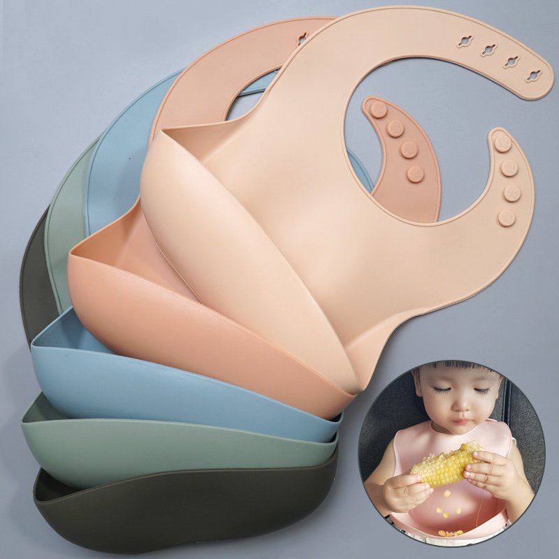 Stacked silicone baby bibs with adjustable neck closures